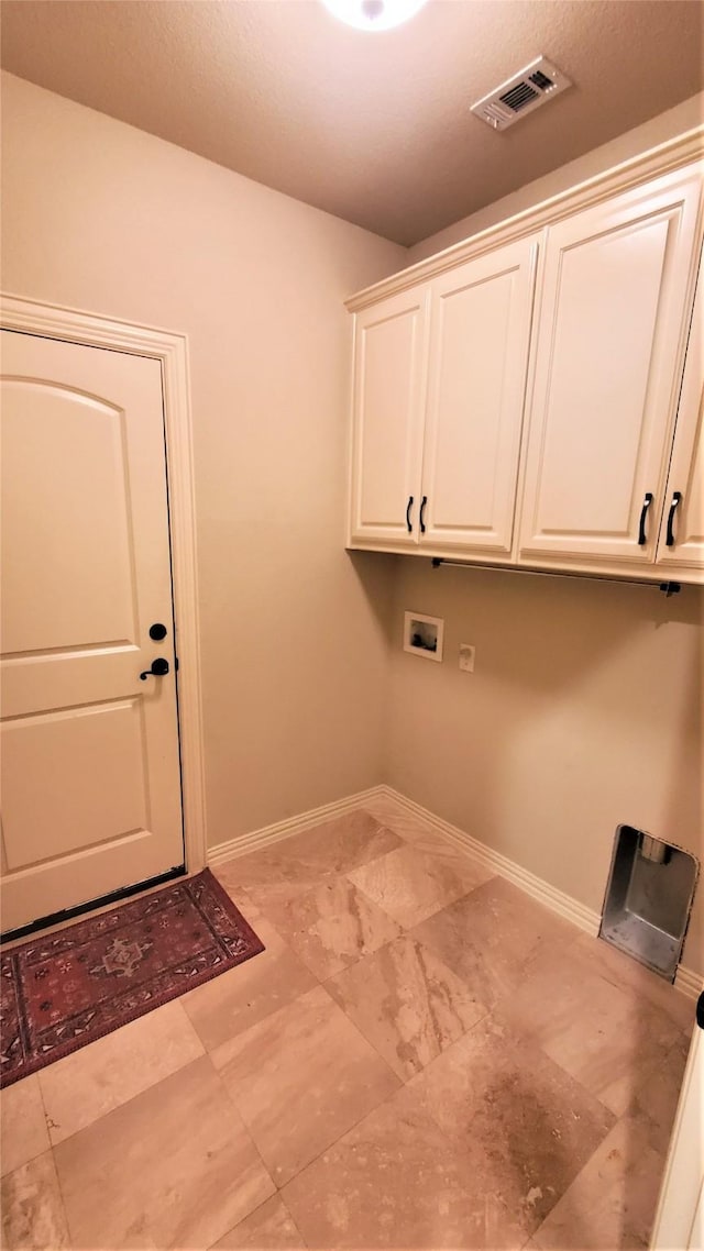washroom with cabinet space, washer hookup, visible vents, and baseboards