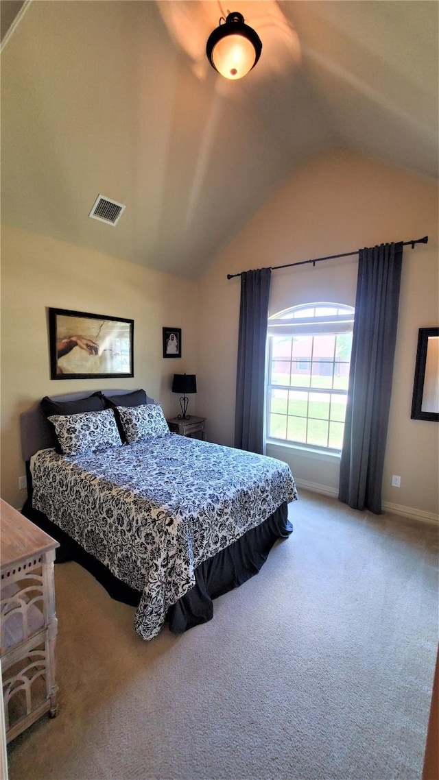 carpeted bedroom featuring baseboards, vaulted ceiling, and visible vents