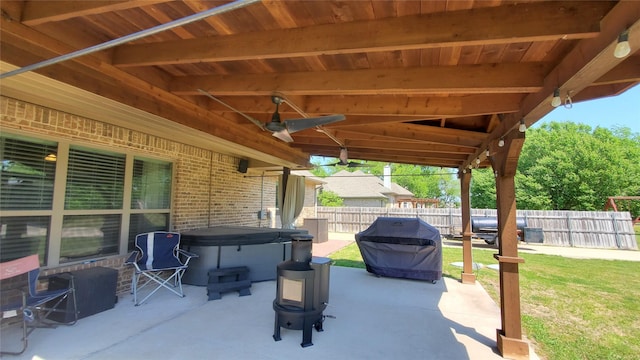 view of patio with a fenced backyard and a hot tub
