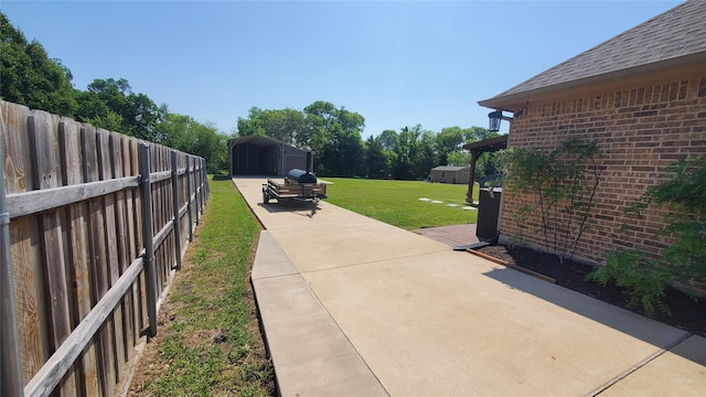 exterior space with fence, an outdoor structure, and a storage unit