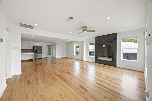 1331 S Denley Dr, Dallas, TX 75216 - unfurnished living room featuring ceiling fan, recessed lighting, light wood-type flooring, baseboards, and a large fireplace