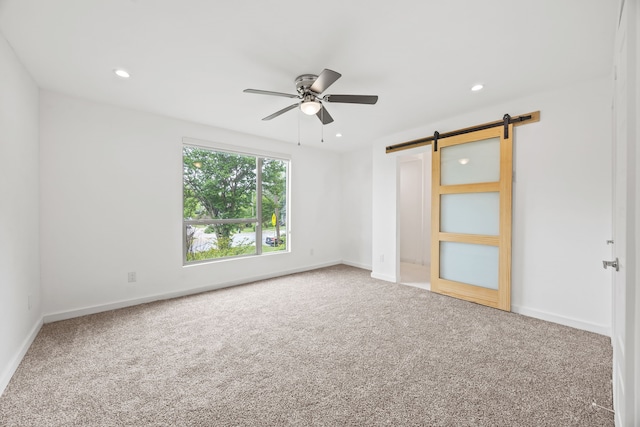 1331 S Denley Dr, Dallas, TX 75216 - unfurnished bedroom with carpet, a barn door, baseboards, recessed lighting, and ceiling fan