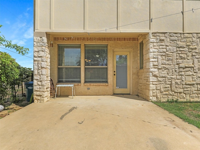 2500 Fountain Cv, Carrollton, TX 75006 - entrance to property featuring a patio and stone siding