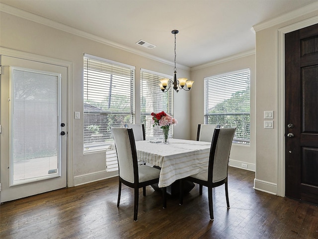 2500 Fountain Cv, Carrollton, TX 75006 - dining area featuring dark wood-style flooring, visible vents, crown molding, baseboards, and a notable chandelier