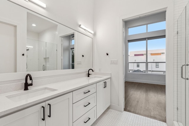 2912 Raleigh St Unit 102, Dallas, TX 75219 - full bathroom with double vanity, a shower stall, baseboards, and a sink