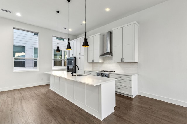 2912 Raleigh St Unit 102, Dallas, TX 75219 - kitchen with a sink, visible vents, wall chimney range hood, and baseboards