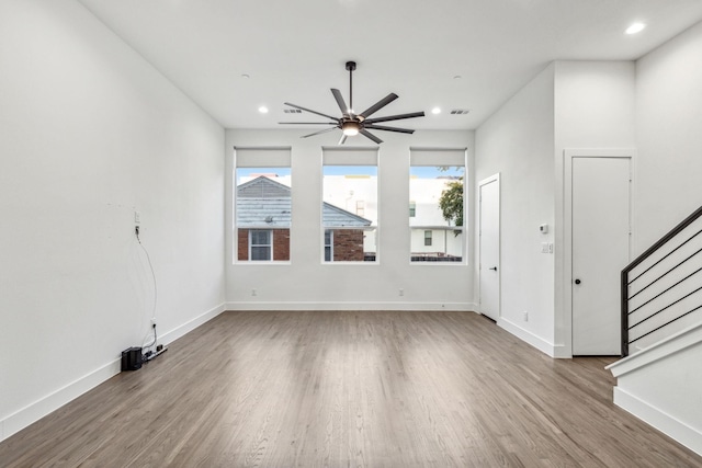 2912 Raleigh St Unit 102, Dallas, TX 75219 - unfurnished living room featuring stairway, ceiling fan, wood finished floors, and baseboards