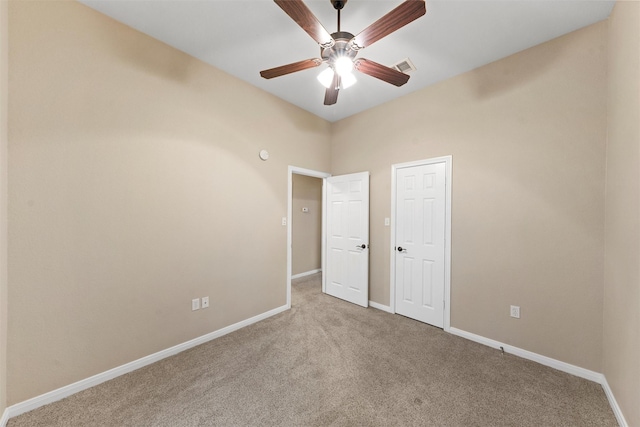 unfurnished bedroom featuring visible vents, a ceiling fan, baseboards, and carpet