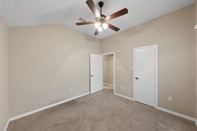 unfurnished bedroom with lofted ceiling, visible vents, a ceiling fan, baseboards, and carpet flooring
