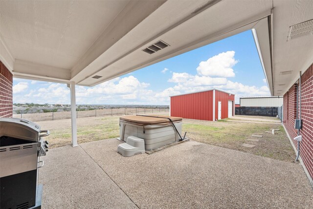 view of patio with fence, an outdoor structure, visible vents, and a grill