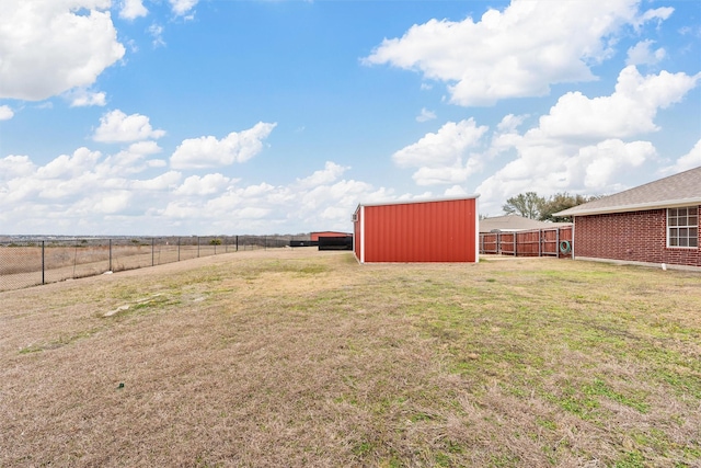 view of yard featuring an outdoor structure, a pole building, and a fenced backyard
