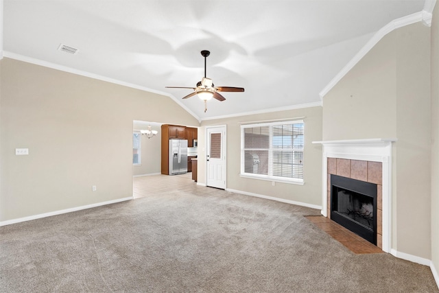unfurnished living room featuring baseboards, visible vents, ceiling fan with notable chandelier, crown molding, and a tile fireplace