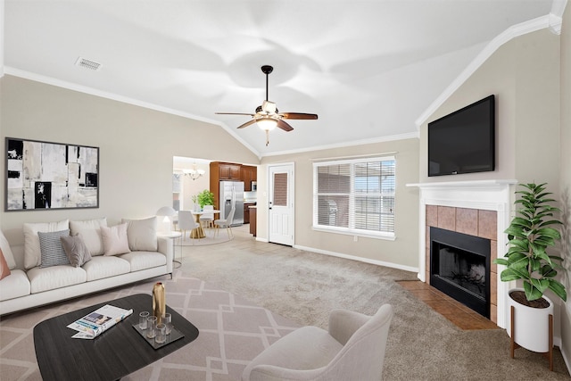 living room featuring light carpet, crown molding, a tile fireplace, and visible vents