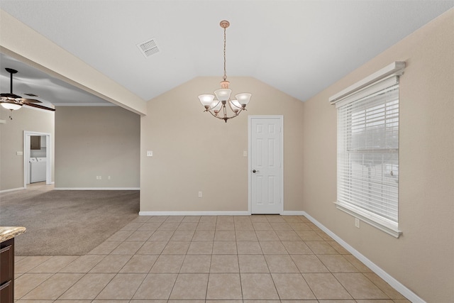 empty room with vaulted ceiling, baseboards, visible vents, ceiling fan with notable chandelier, and washer / dryer