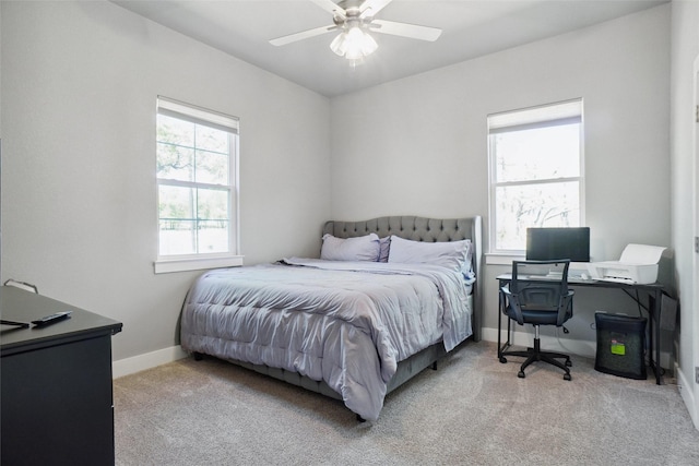 bedroom with ceiling fan, baseboards, and carpet