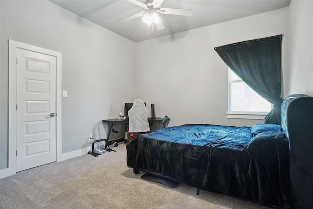 carpeted bedroom featuring a ceiling fan and baseboards