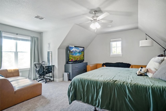 bedroom featuring carpet floors, visible vents, lofted ceiling, and ceiling fan