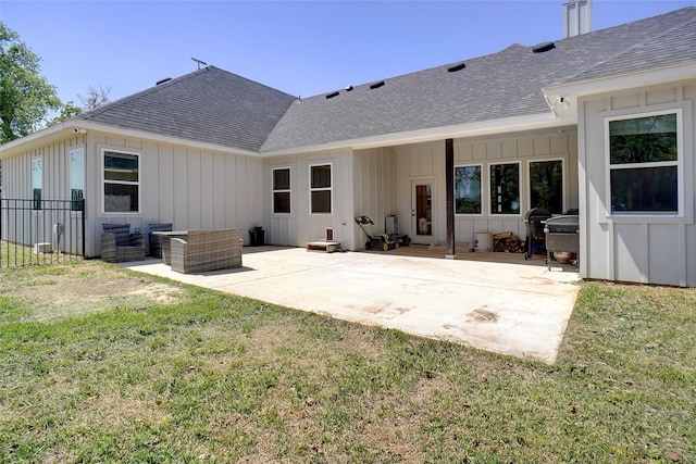 back of house featuring board and batten siding, a shingled roof, and a patio