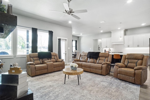 living room featuring light wood finished floors, recessed lighting, and ceiling fan