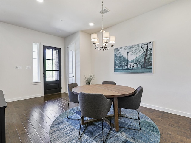 dining space featuring a chandelier, wood finished floors, baseboards, and recessed lighting
