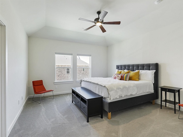 bedroom featuring a ceiling fan, baseboards, vaulted ceiling, and light colored carpet