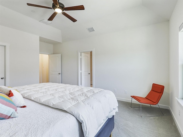 bedroom with lofted ceiling, visible vents, carpet flooring, and baseboards
