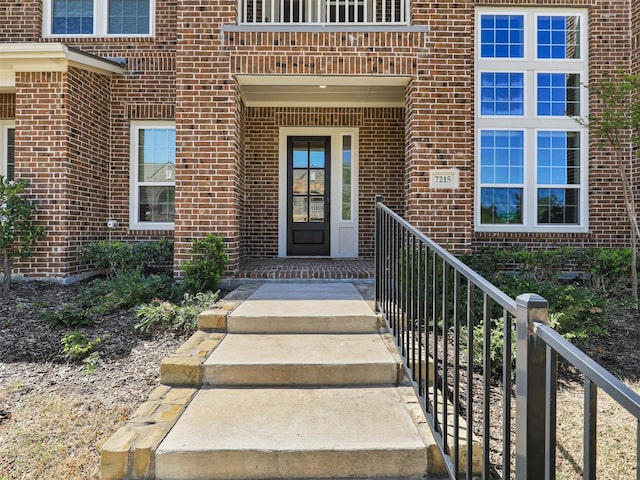 view of exterior entry with brick siding
