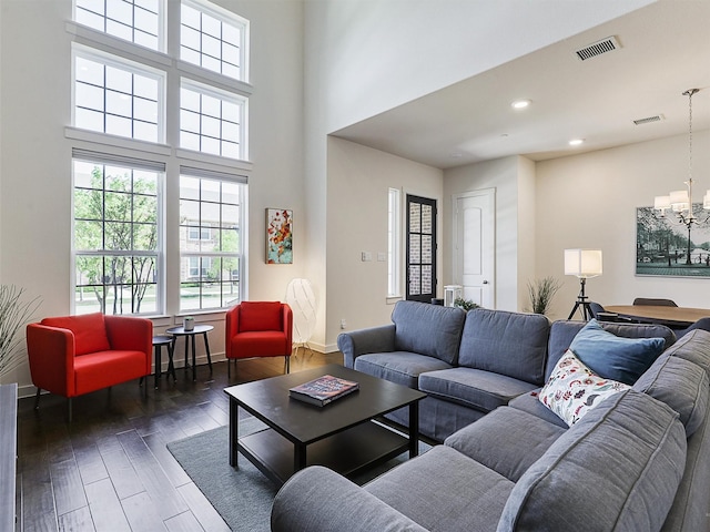 living room with wood finished floors, visible vents, recessed lighting, and a chandelier