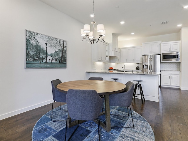 dining space with dark wood-style flooring, baseboards, visible vents, recessed lighting, and a notable chandelier