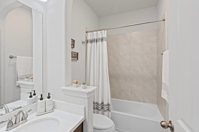bathroom featuring shower / tub combo, toilet, and vanity
