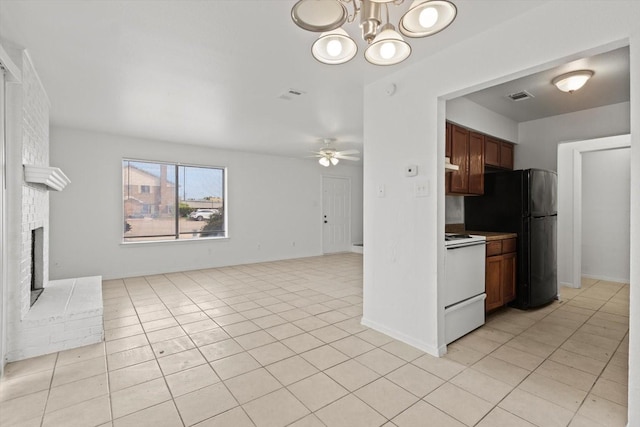 kitchen with open floor plan, electric stove, visible vents, and freestanding refrigerator