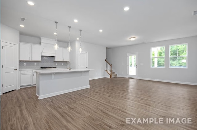 1717 Zachary Ave, Wylie, TX 75098 - kitchen with light countertops, decorative backsplash, open floor plan, and white cabinetry