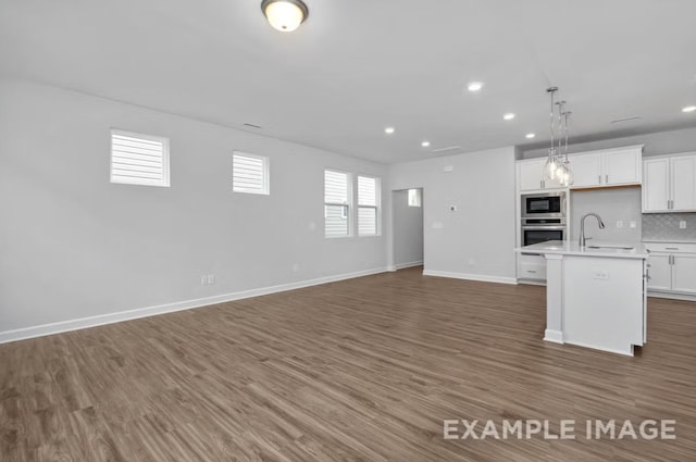 1717 Zachary Ave, Wylie, TX 75098 - kitchen featuring built in microwave, open floor plan, stainless steel oven, light countertops, and recessed lighting