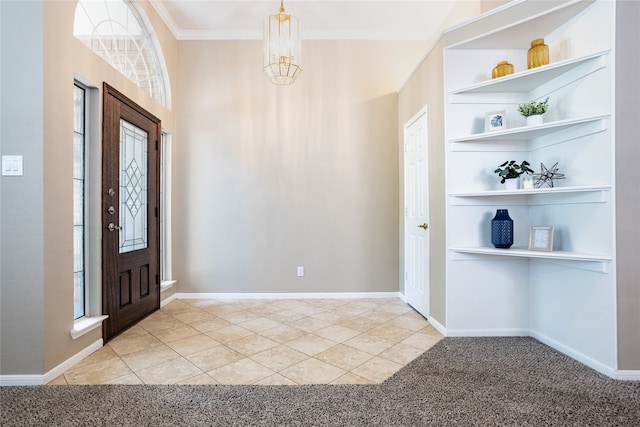 foyer with light carpet, light tile patterned floors, ornamental molding, a chandelier, and baseboards