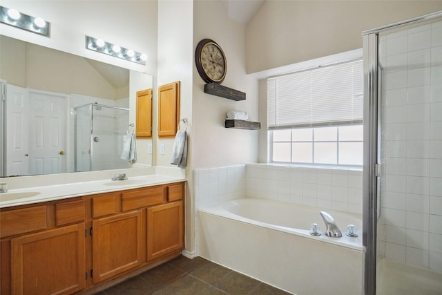 bathroom featuring a shower stall, a garden tub, tile patterned floors, a sink, and double vanity