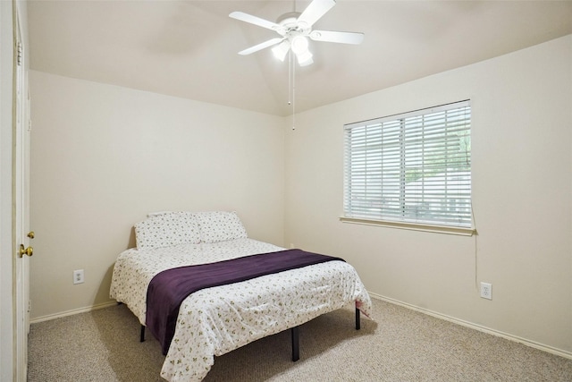 carpeted bedroom with ceiling fan, baseboards, and vaulted ceiling