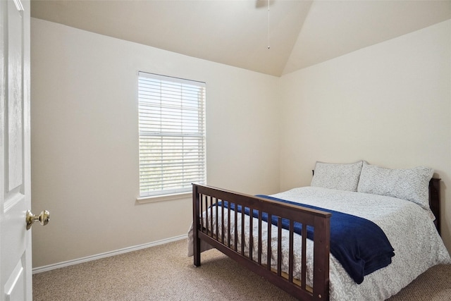 bedroom featuring lofted ceiling, carpet flooring, and baseboards