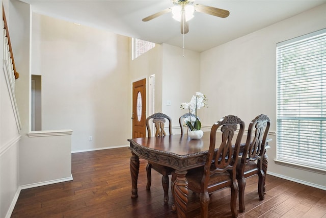 dining area featuring baseboards, a healthy amount of sunlight, a ceiling fan, and hardwood / wood-style flooring
