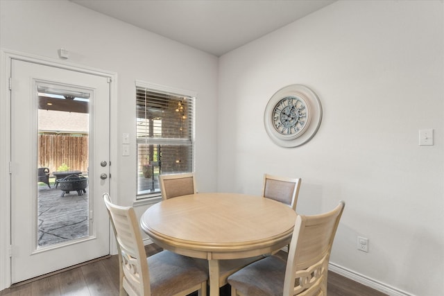 dining area featuring baseboards and wood finished floors