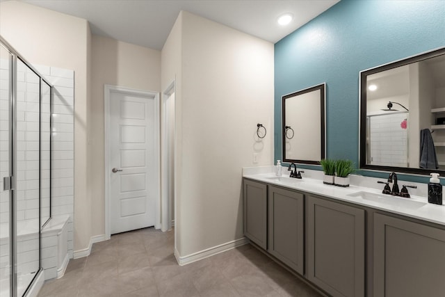 bathroom featuring a sink, double vanity, and a stall shower
