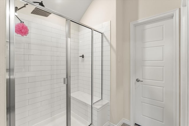 bathroom featuring baseboards and a stall shower