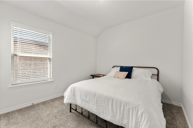 bedroom featuring lofted ceiling, baseboards, and carpet flooring