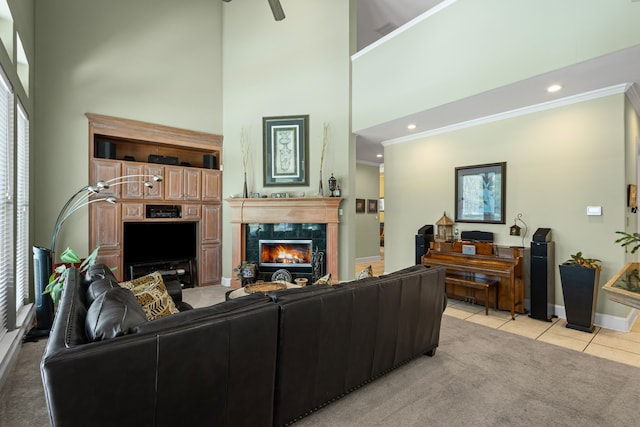 720 Castle Creek Dr, Coppell, TX 75019 - living area featuring a towering ceiling, tile patterned flooring, a premium fireplace, baseboards, and crown molding