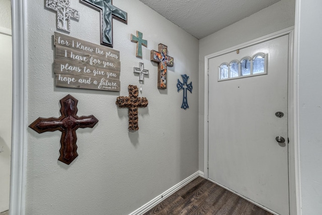 106 Guinevere Ct, Weatherford, TX 76086 - doorway featuring baseboards, dark wood-style flooring, and a textured ceiling