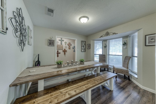 106 Guinevere Ct, Weatherford, TX 76086 - dining room featuring visible vents, a textured ceiling, dark wood finished floors, and baseboards