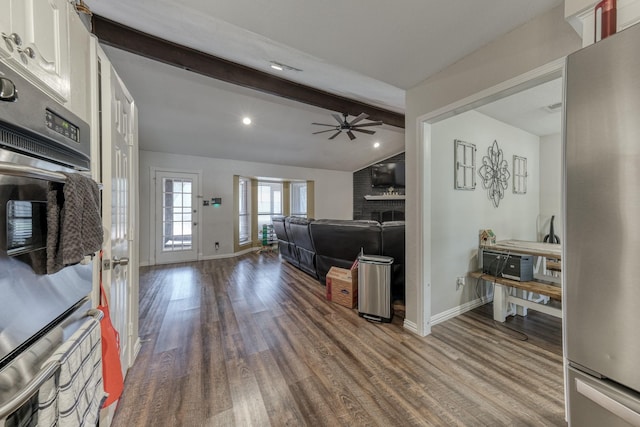 106 Guinevere Ct, Weatherford, TX 76086 - living area with baseboards, a brick fireplace, wood finished floors, and vaulted ceiling with beams