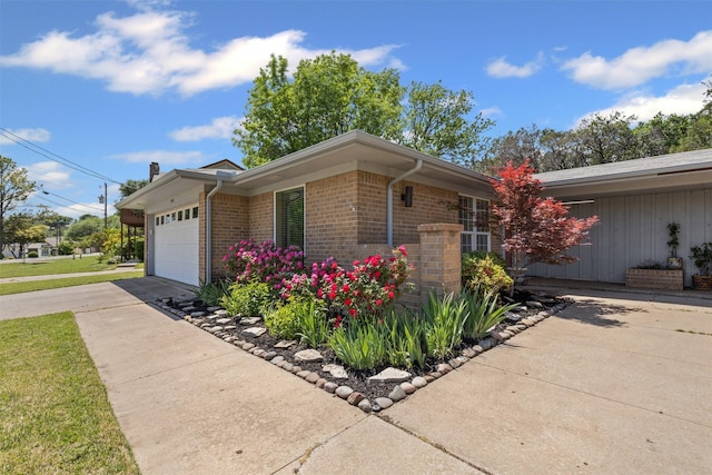5008 Santa Elena Ct, Granbury, TX 76049 - view of side of home featuring an attached garage, brick siding, and concrete driveway