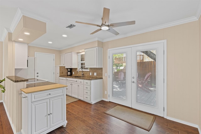 5008 Santa Elena Ct, Granbury, TX 76049 - kitchen with dark wood finished floors, visible vents, french doors, a sink, and white cabinetry