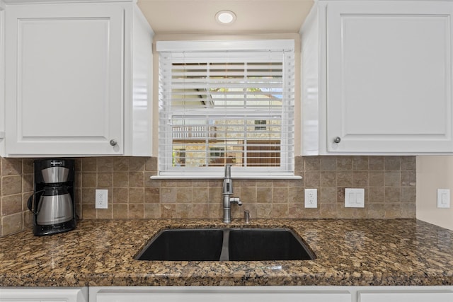 5008 Santa Elena Ct, Granbury, TX 76049 - kitchen featuring decorative backsplash, a sink, white cabinetry, and dark stone counters