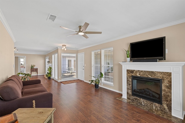 5008 Santa Elena Ct, Granbury, TX 76049 - living area with wood finished floors, visible vents, a fireplace, and crown molding
